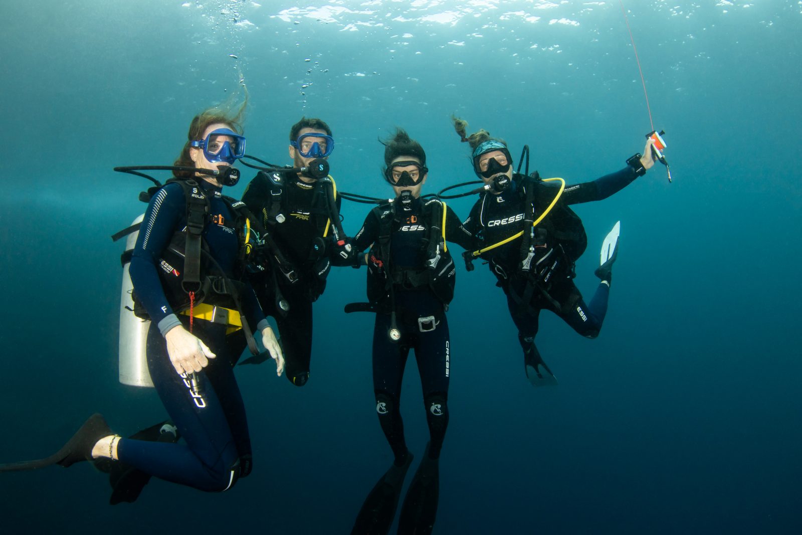 Smiling dive group at the safety stop
