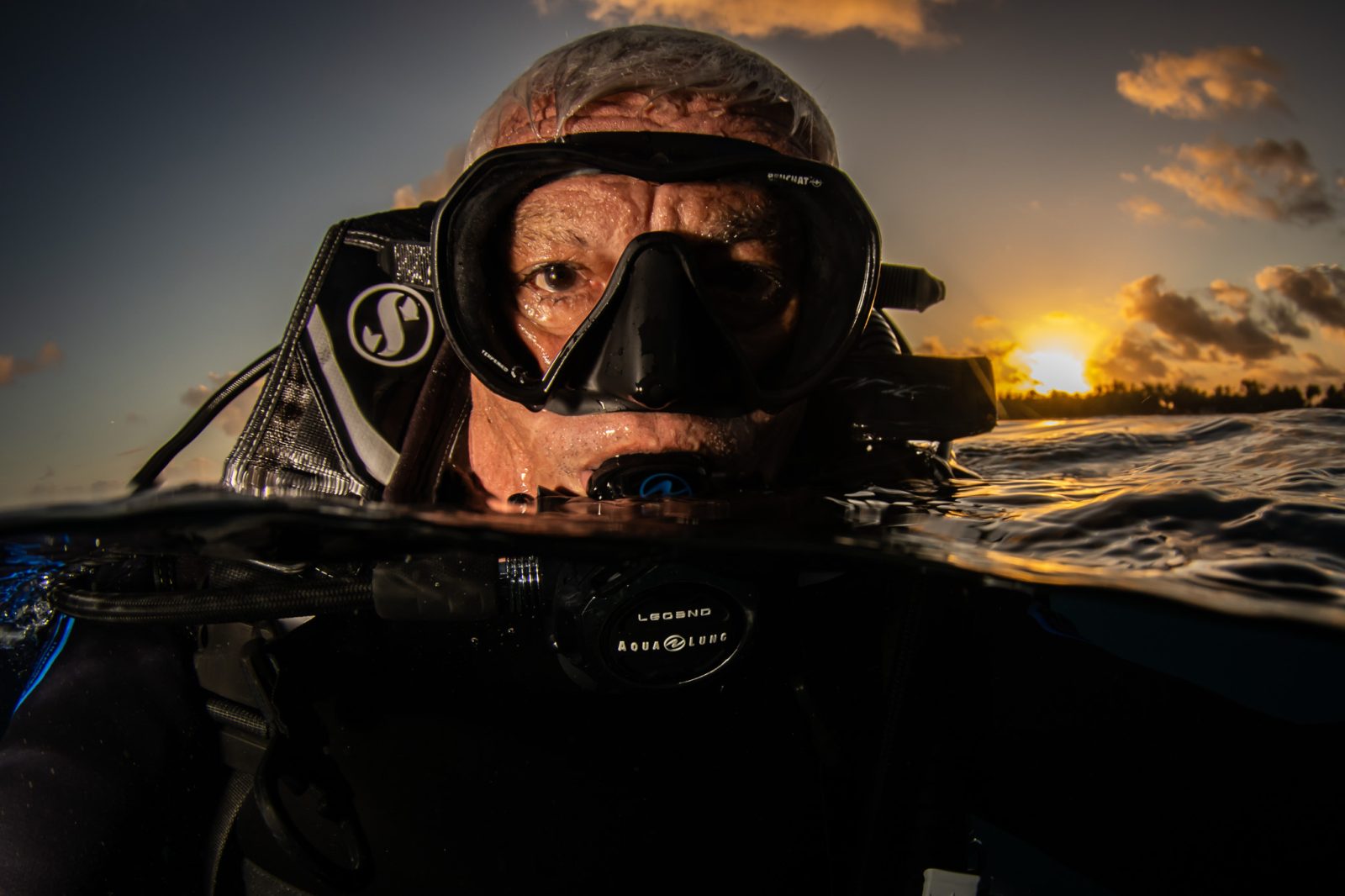 Photographer Bernard Beaussier at the surface at sunset