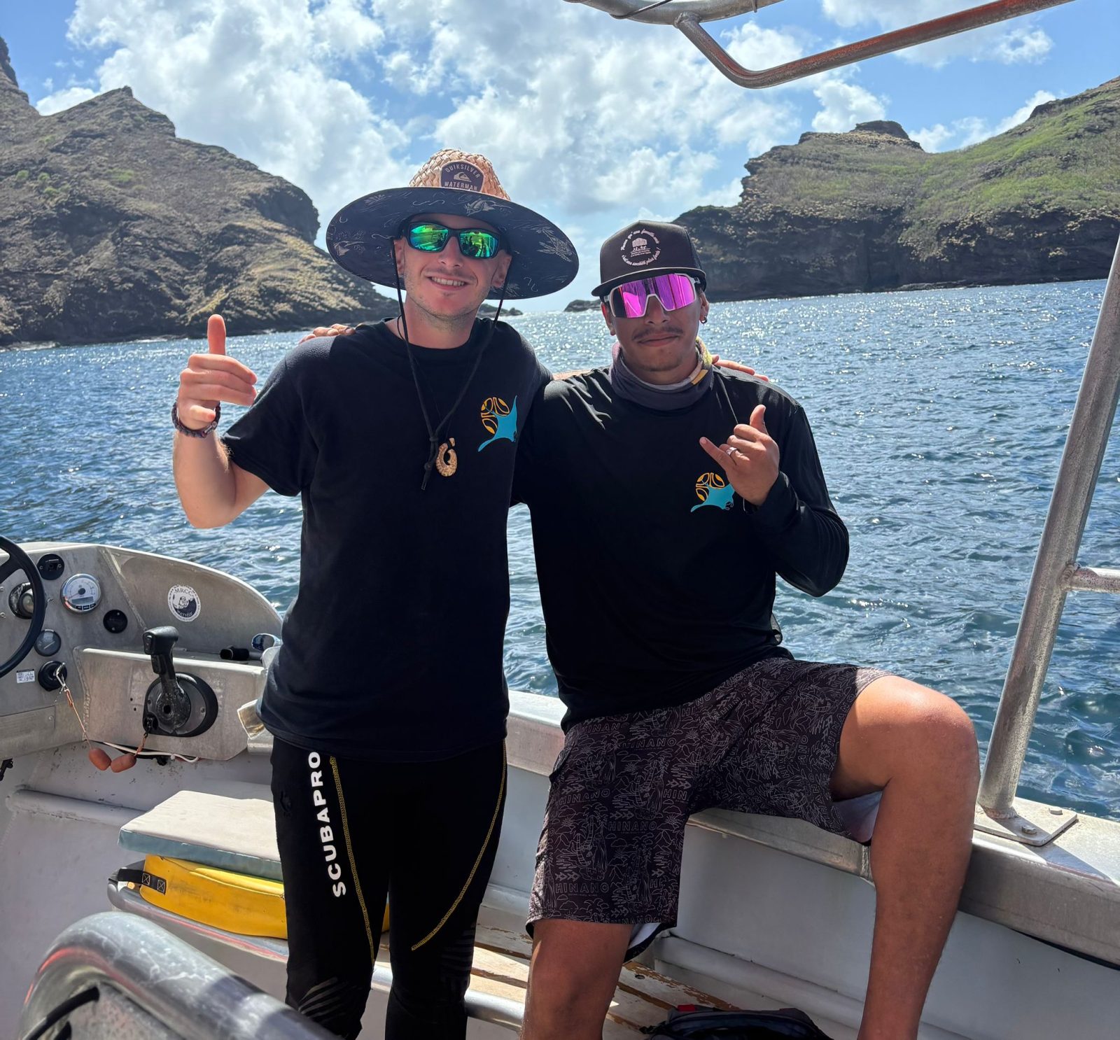 Hugues and Kipiri on board in front of the cliffs